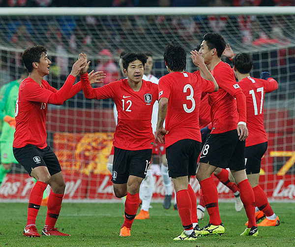 Futbolistas coreanos celebran un gol en amistoso contra Polonia