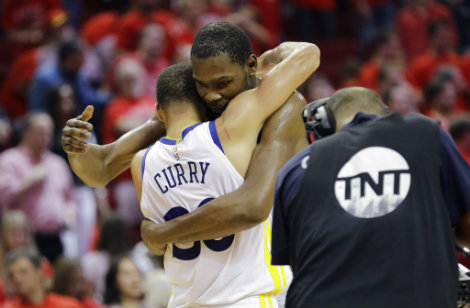 Durant y Curry se abrazan durante partido