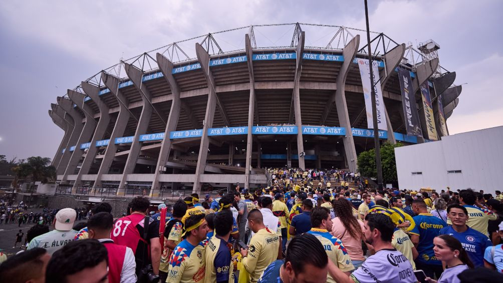 Afición se resguarda de la lluvia en el Estadio Azteca