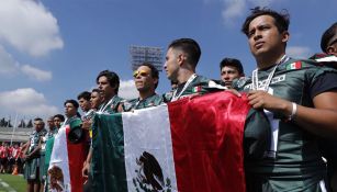 Jugadores de México sostienen la bandera nacional