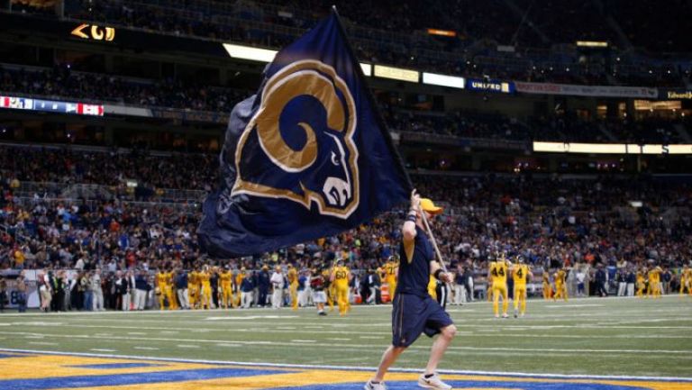 Aficionado de Rams corre con una bandera en el Edward Jones Dome