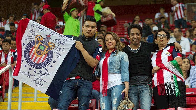Los aficionados de Chivas portando la bandera del Rebaño