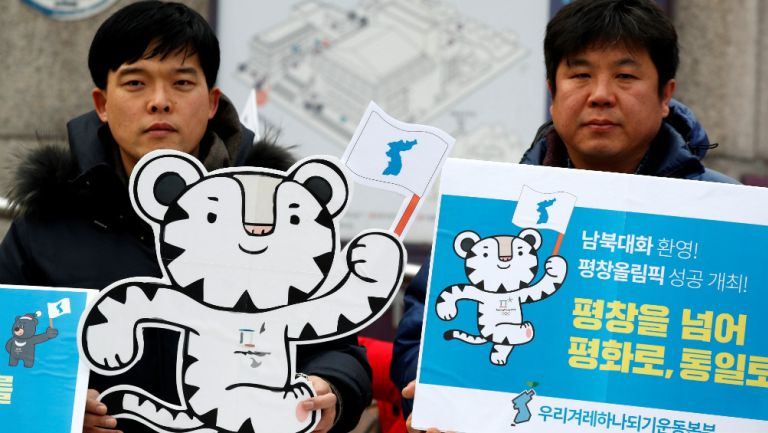 Coreanos posan junto a la mascota de los JO de Invierno 