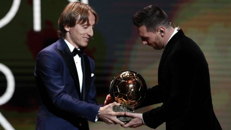 Luka Modric dando el Balón de Oro a Lionel Messi
