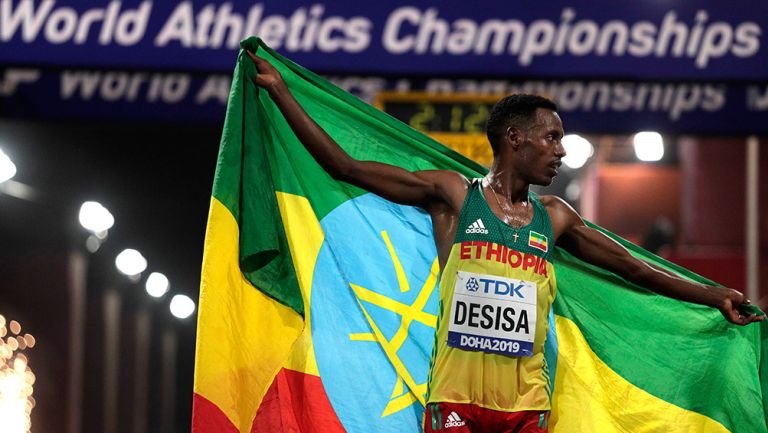 El etíope Desisa muestra su bandera tras ganar el Maratón en 2019